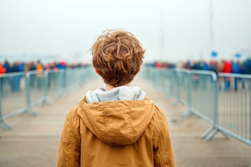 Child watching airshow from fenced area