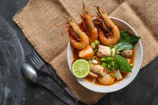 Tom yam soup originating from Thailand. Tom yum is made with shrimp, chili, lime, chicken, fish, or seafood and mushrooms.