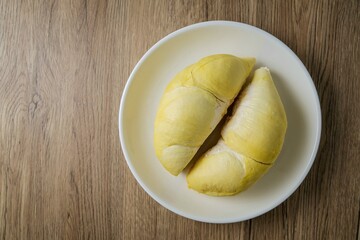 Fresh Durian on white plate , wooden background, , top view food table, fruit	