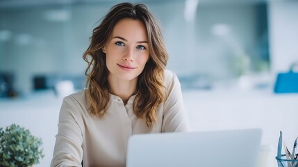 Confident woman working on laptop in modern office.