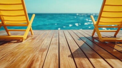 Two yellow lounge chairs sit peacefully on a wooden deck overlooking the clear blue sea, evoking feelings of relaxation and leisure under the summer sun.