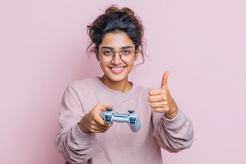 Happy Indian gamer giving a thumbs up with a controller after a win Excited woman celebrating making an approving gesture in a studio setting