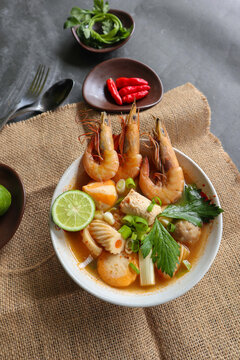 Tom yam soup originating from Thailand. Tom yum is made with shrimp, chili, lime, chicken, fish, or seafood and mushrooms.
