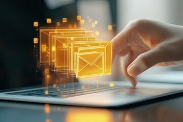 Hand interacting with holographic email icons over a laptop