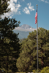 American Flag at Beaver Meadows Visitor Center frames Longs Peak within Rocky Mountain National Park, Colorado