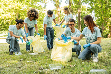Group of volunteer cleaning picking up plastic litter in the park - Diverse group of people collect trash in the forest - Environmental protection, non profits organization and save the planet concept