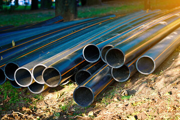 Plastic hdpe pipe tubing neatly stored on the lawn for use in electric conduit infrastructure...