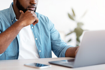 Busy Black Entrepreneur Working With Laptop At Office, Unrecognizable African Businessman Sitting...