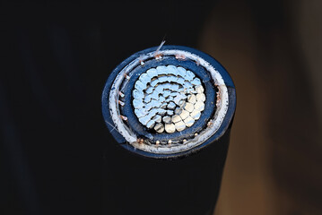 High voltage electrical cable cross-section showing internal conductive metal strands, insulation...