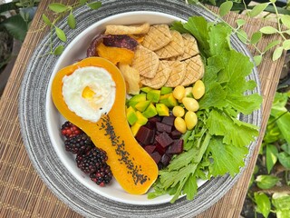 Baked tofu and Soft boiled egg in butterscotch with mixed salad on top with sesame dressing
