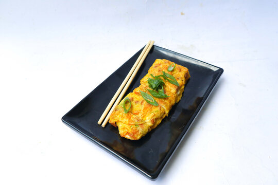 Telur dadar gulung or Tamagoyaki or Japaneses egg roll. Gyeran Mari or Korean Rolled Omelette. fried egg isolate white background