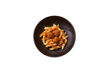 Penne pasta with meatballs in tomato sauce with salt and spices. Italian food penne pasta