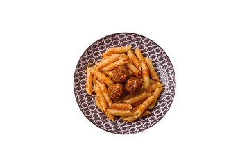 Penne pasta with meatballs in tomato sauce with salt and spices. Italian food penne pasta