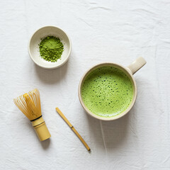 Ceremonial-style matcha latte with bamboo whisk and powder. Minimalist Japanese tea presentation with clean, calming design.