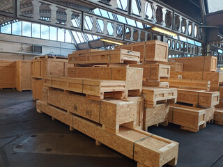 Industrial wooden crates stacked in warehouse ready for packaging and shipping.