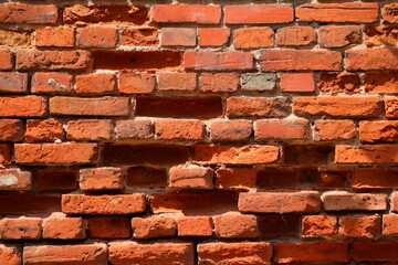 Red brick wall with brick holes