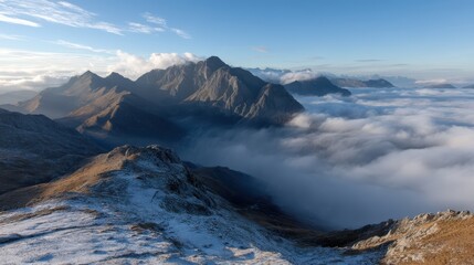 Obraz premium Rocky mountain summit view over a sea of low-lying clouds