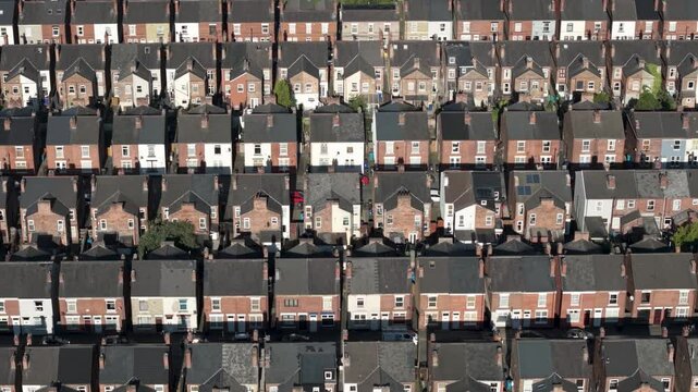 Aerial view above rows of terraced houses on a large council estate