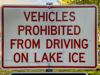 white warning sign with bold red inscription 