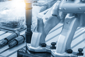 Automotive parts assembly process by the pneumatic wrench in the light blue scene.