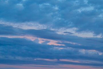 Clouds in sunset reflections: a gradient from magenta to lilac. Calm clouds tinted with rich...