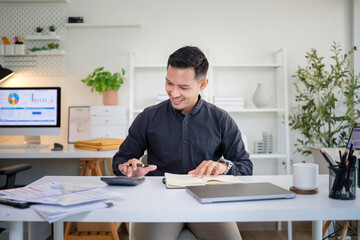 Professional bookkeeper working on financial reports, calculating expenses and recording figures in...