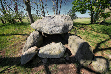 Ancient stone chamber Hoher Stein in Germany made of balanced boulders in wooded landscape near...