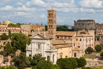 Top view of the Roman forum with the basilica Santa Francesca Romana and Colosseum in the background. Rome, Italy