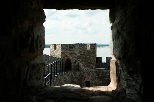 View of a stone watchtower at Ram Fortress seen through a narrow castle window. A popular tourist destination in Serbia