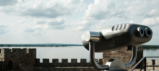 Coin-operated binocular viewer set up on a tower of Ram Fortress, facing the Danube River. A popular tourist destination in Serbia country