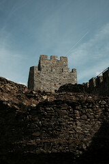 Medieval stone walls and ruins of Ram Fortress under a bright sky in Serbia. A popular tourist destination
