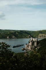 Panoramic scene of Golubac Fortress and Danube River with a cruise ship passing by. A popular tourist destination in Serbia