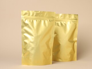 Zipper stand-up pouches on beige background. Mockup for design