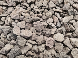 Background of split stones. Piles of split stones for decoration and building materials. It is in...