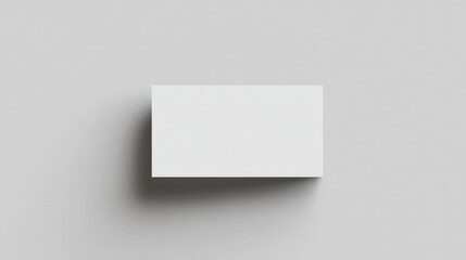 Fototapeta premium Minimalist White Blank Card Standing Vertically on White Background for Presentation Mockup and Design Layouts in Modern Style