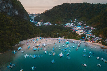 Bangka boats resting in Clear Skies and Peaceful Blue Horizon Over Coastal Paradise of El Nido’s Corong Corong Beach