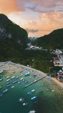 Bangka boats resting in Clear Skies and Peaceful Blue Horizon Over Coastal Paradise of El Nido&rsquo;s Corong Corong Beach