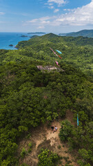 Couple Tourists at Mt. Mansilawit View Deck Overlooking the Island-Dotted Sea of El Nido, Palawan, Philippines