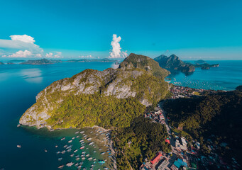 Aerial shot of El Nido town with islands in a Tranquil Sunset Over Corong Corong Beach, El Nido, Palawan,  Philippines.