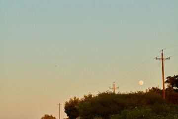 Full Moon Rising Over Mountain Ridge at Dusk
