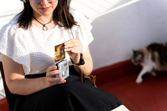 Young woman listening to music with a portable minidisc player