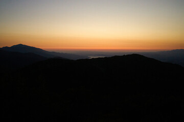 Mountain Silhouette at Sunset with Orange Sky
