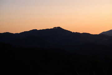 Mountain Silhouette at Sunset with Orange Sky
