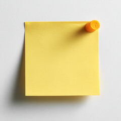 Vibrant yellow sticky note with round orange adhesive dot on clean white background creates cheerful and organized workspace