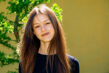 Fototapeta premium Beautiful teenage girl, portrait on the street outside the city.