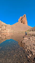 Quiet Ibón de Lavasar with the imposing Lavasar Needles reflected in its crystal clear waters, natural landscape of the Pyrenees in the Chistau Valley, Aragon.
