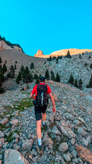 Trekker mountaineer moving towards the Agujas de Lavasar, surrounded by impressive peaks and rocky terrain in the heart of the Aragon Pyrenees, Chistau Valley.
