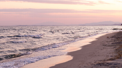 Pink Mediterranean sunset on the cost of the sea