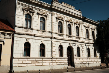 Historic building with arched windows and classical decorative elements in town Vrsac, Serbia.