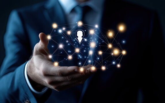 Businessman's hand holds a digital network centered on a person icon